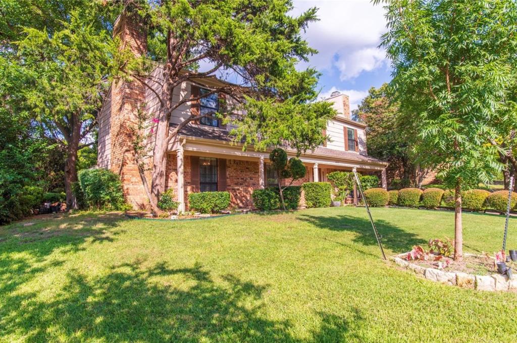 4013 18th Street Plano, TX 75074 - Photo 4 of 39 a front view of a house with a garden and yard
