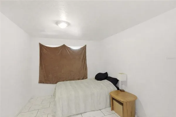 a bedroom with a bed and a wall painting