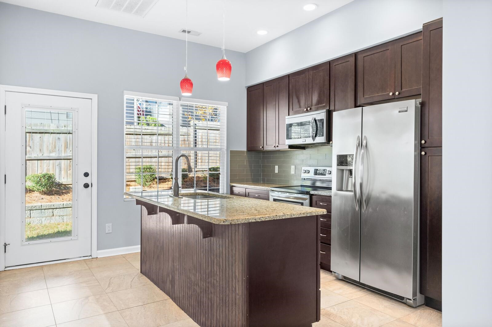 129 Pineland Circle, Unit 100 Raleigh, NC 27606 - Photo 7 of 29 a kitchen with stainless steel appliances granite countertop a refrigerator and a sink
