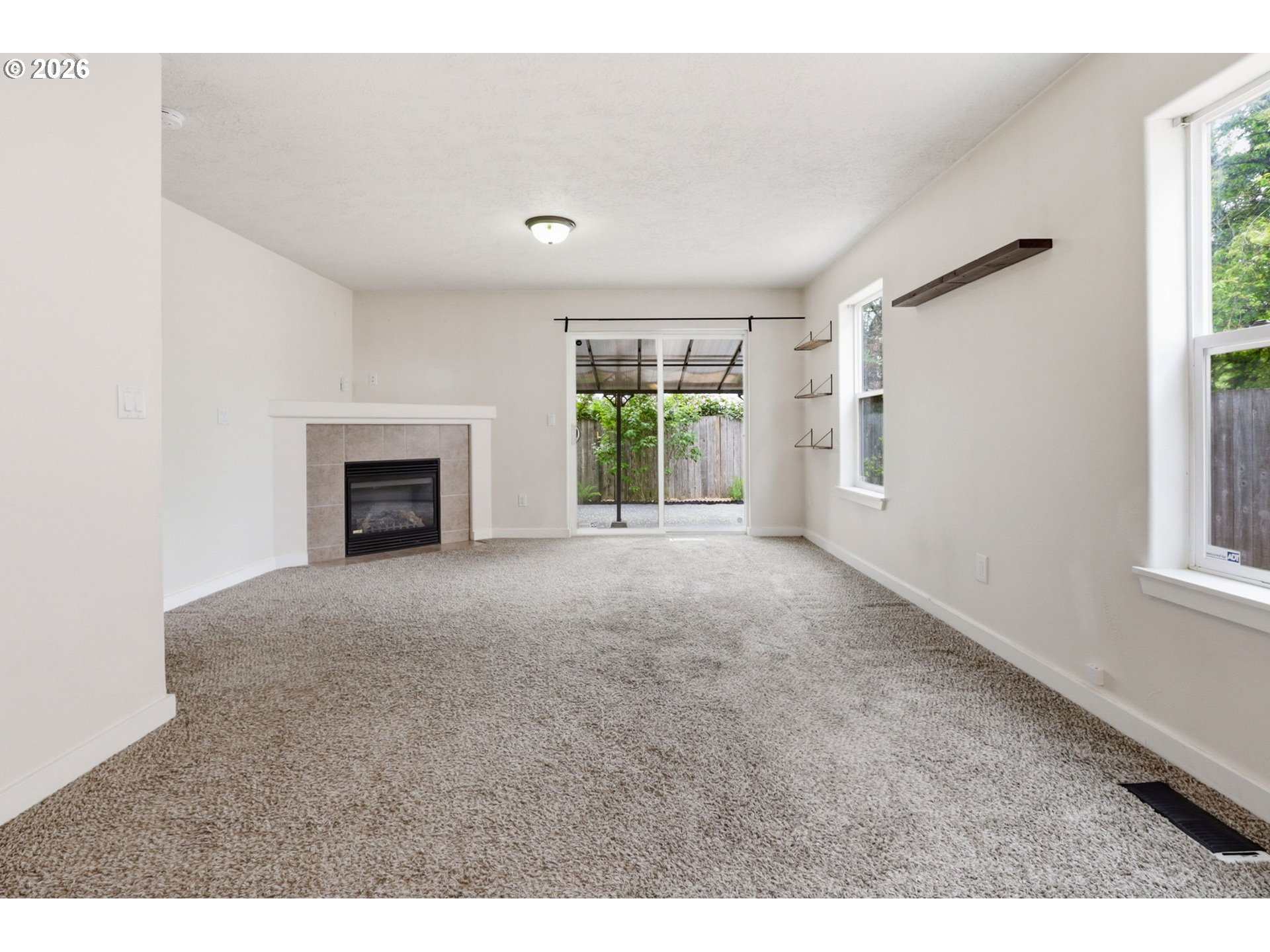 581 Southeast 204th Place Gresham, OR 97030 - Photo 11 of 32 a view of an empty room with window and fire place