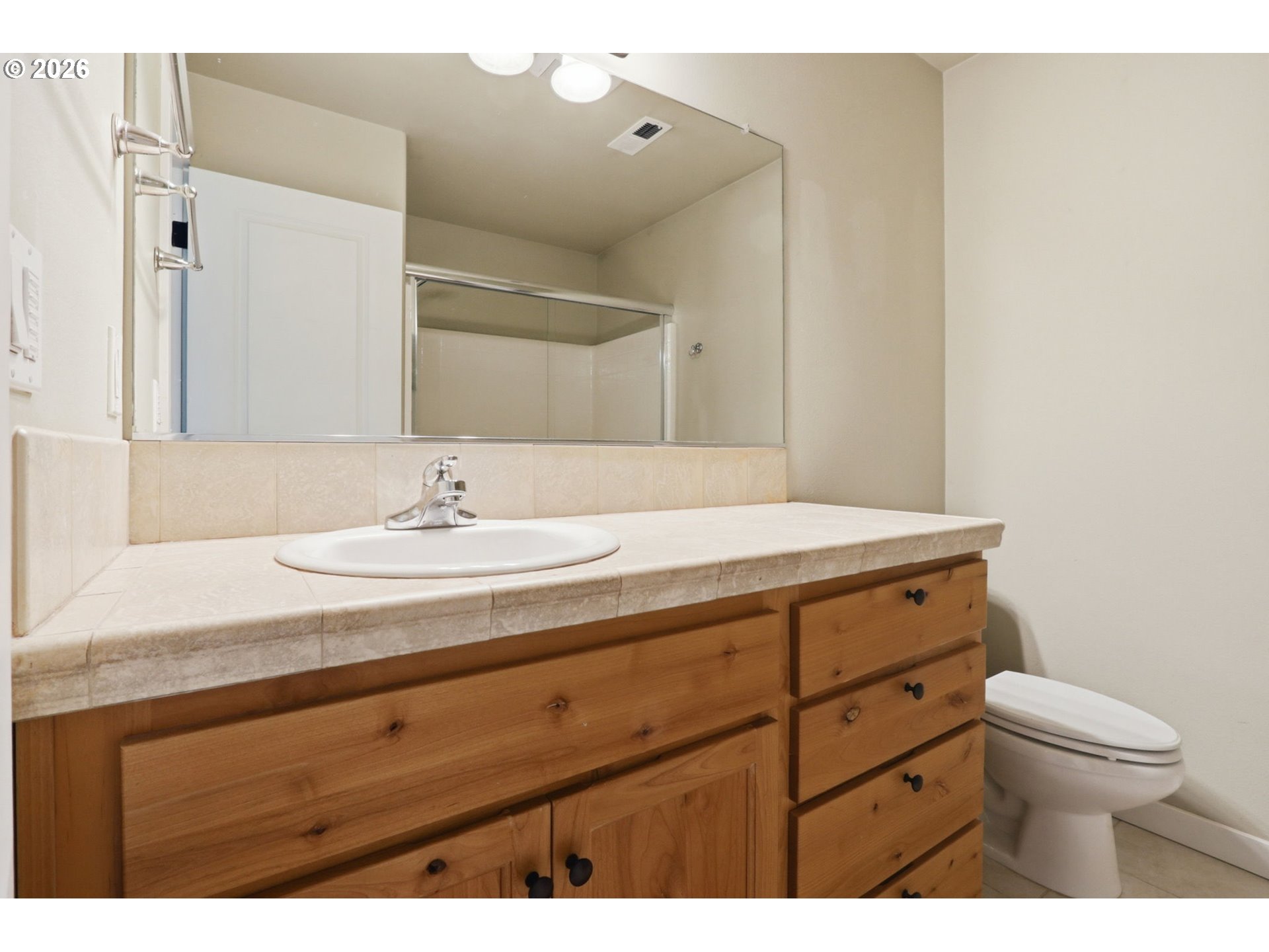 581 Southeast 204th Place Gresham, OR 97030 - Photo 22 of 32 a bathroom with a sink a toilet and a mirror