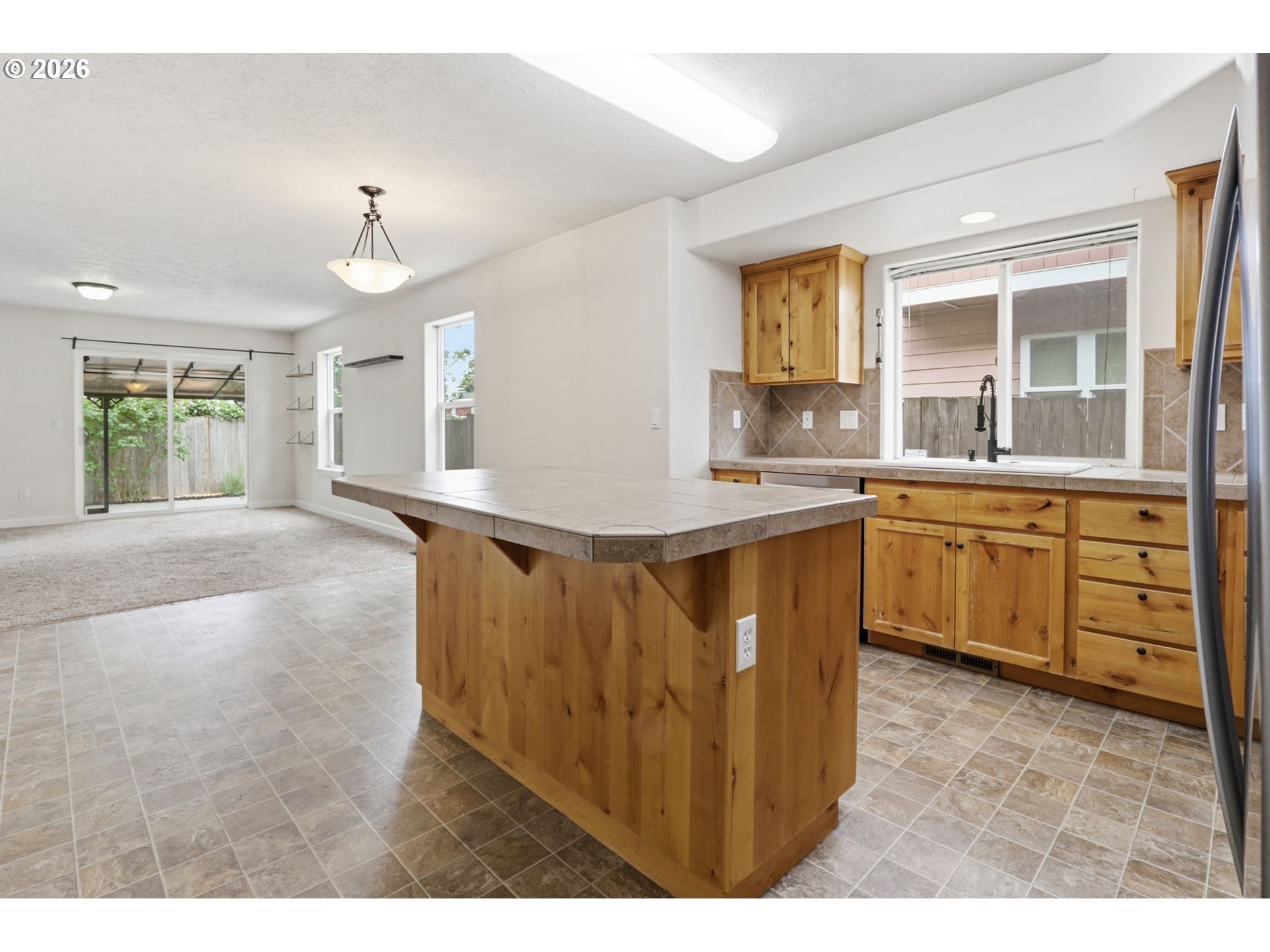 581 Southeast 204th Place Gresham, OR 97030 - Photo 4 of 32 a view of a kitchen with cabinets and wooden floor