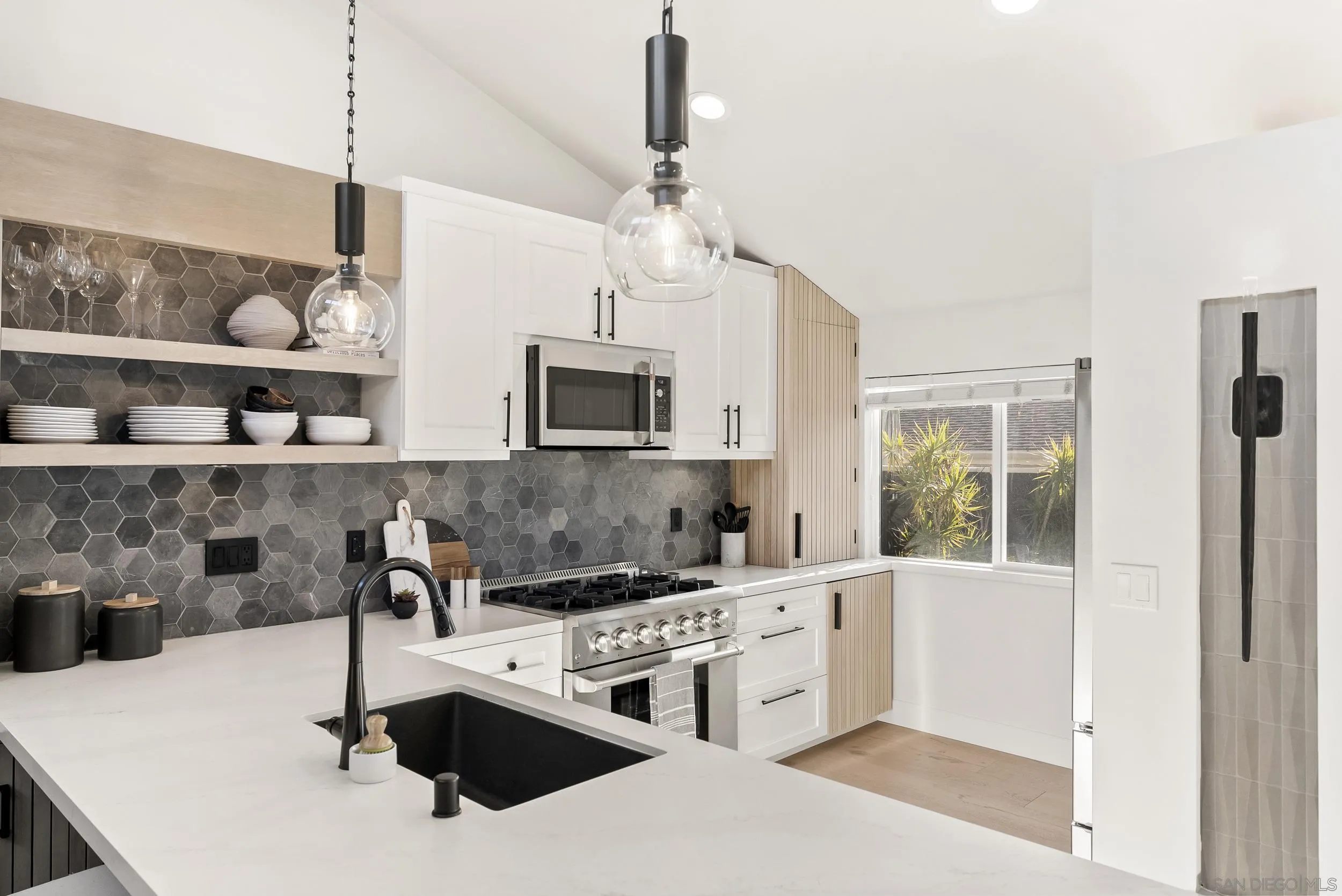 1873 Haymarket Road Encinitas, CA 92024 - Photo 4 of 16 a kitchen with a sink a stove and cabinets