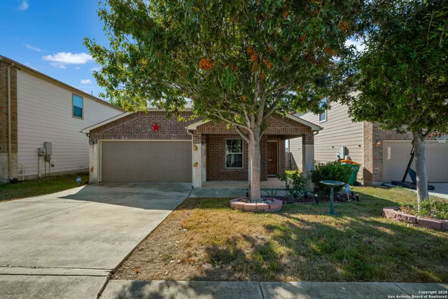 a front view of house with yard and green space