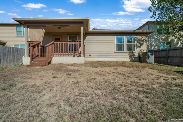 a view of a house with wooden fence