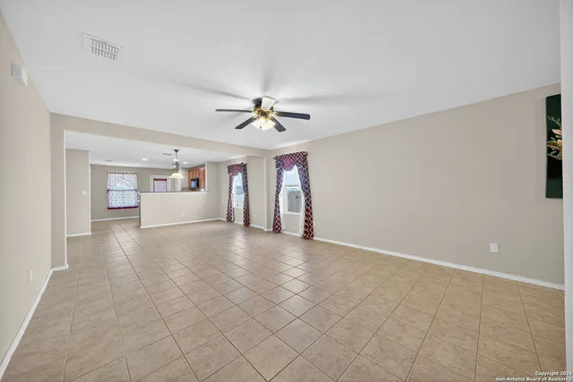 a view of a livingroom with furniture and chandelier fan