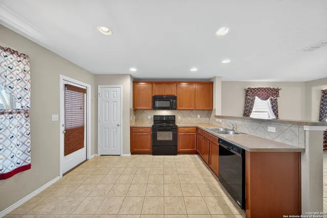 a large kitchen with stainless steel appliances granite countertop a large counter top and oven
