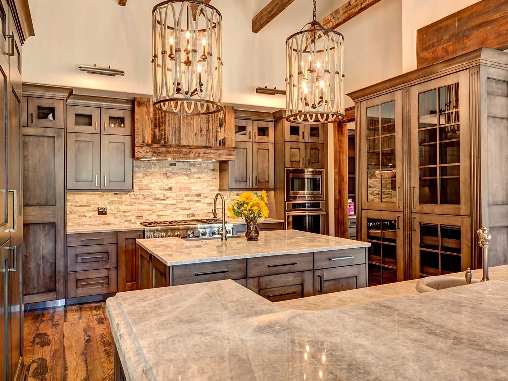 314 Peerless Drive Breckenridge, CO 80424 - Photo 3 of 25 a view of a kitchen with stainless steel appliances kitchen island granite countertop a stove and a chandelier