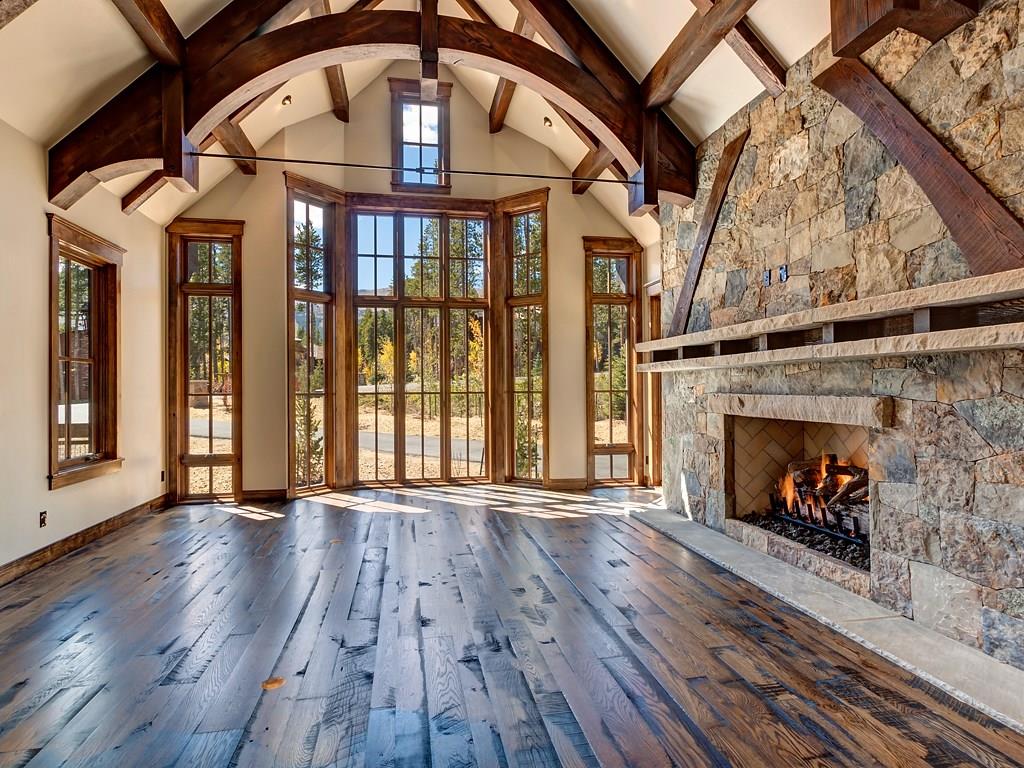 314 Peerless Drive Breckenridge, CO 80424 - Photo 6 of 25 an empty room with wooden floor fireplace and windows