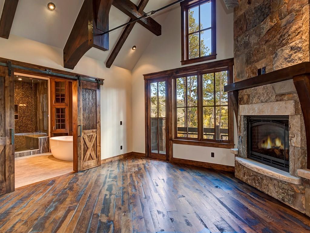 314 Peerless Drive Breckenridge, CO 80424 - Photo 7 of 25 a view of an empty room with wooden floor fireplace and a window