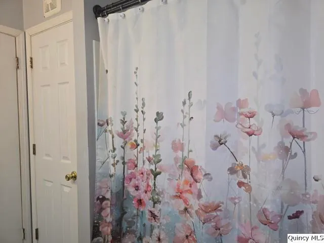 a bathroom with a shower curtain