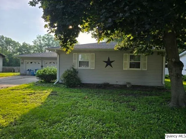 a view of backyard with outdoor seating and green space