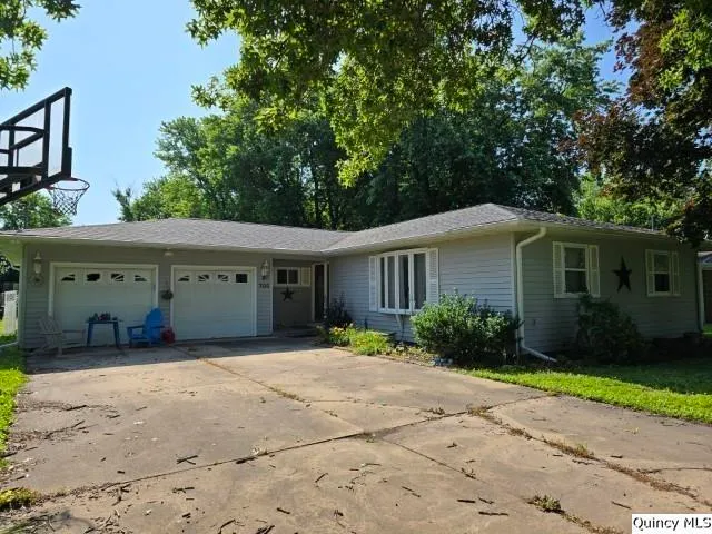 a front view of a house with a yard and a garage