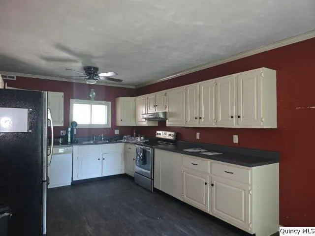 a kitchen with granite countertop a sink and cabinets