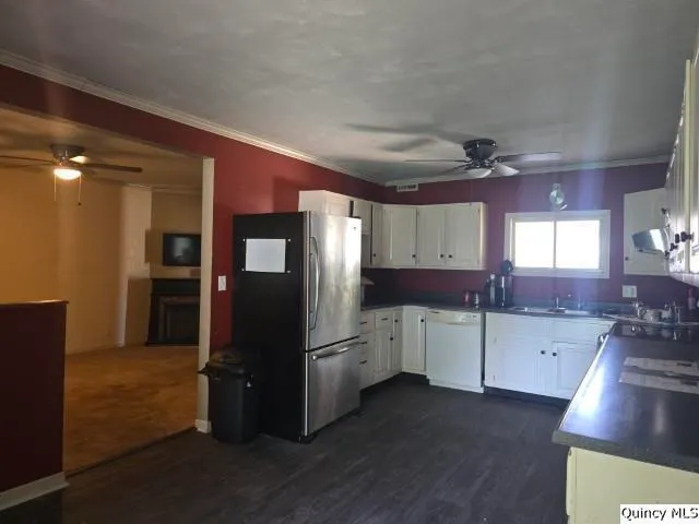 a kitchen with a refrigerator and a sink