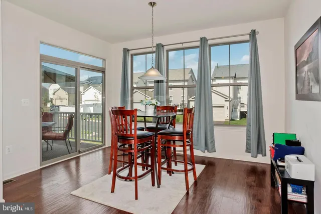a dining room with furniture wooden floor and a chandelier