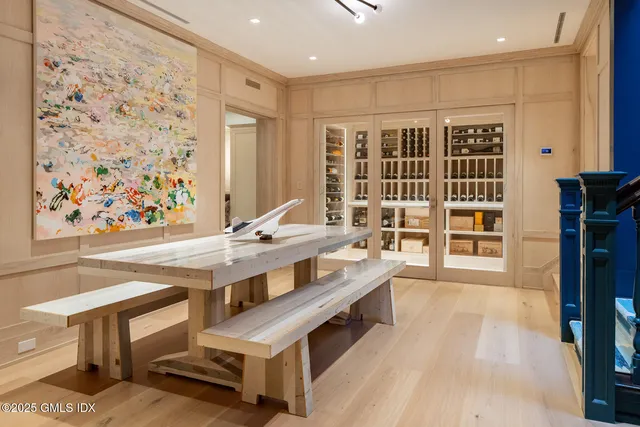 a view of a kitchen with kitchen island a sink wooden floor and a dining table