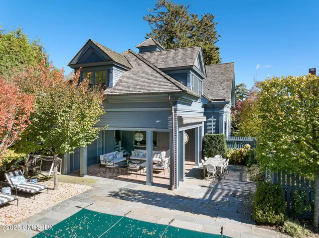 a front view of a house with sitting area