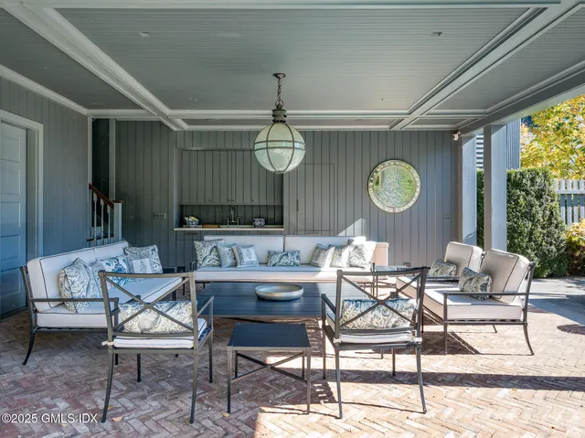 a living room with couches and a dining table with kitchen view