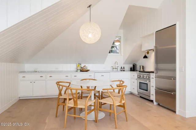a kitchen with a dining table and chairs
