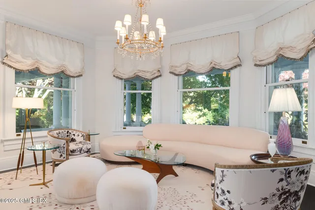 a living room with furniture chandelier and a chandelier