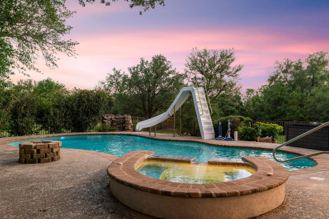 1237 Ridge Harbor Drive Spicewood, TX 78669 - Photo 2 of 40 a view of a swimming pool with a yard
