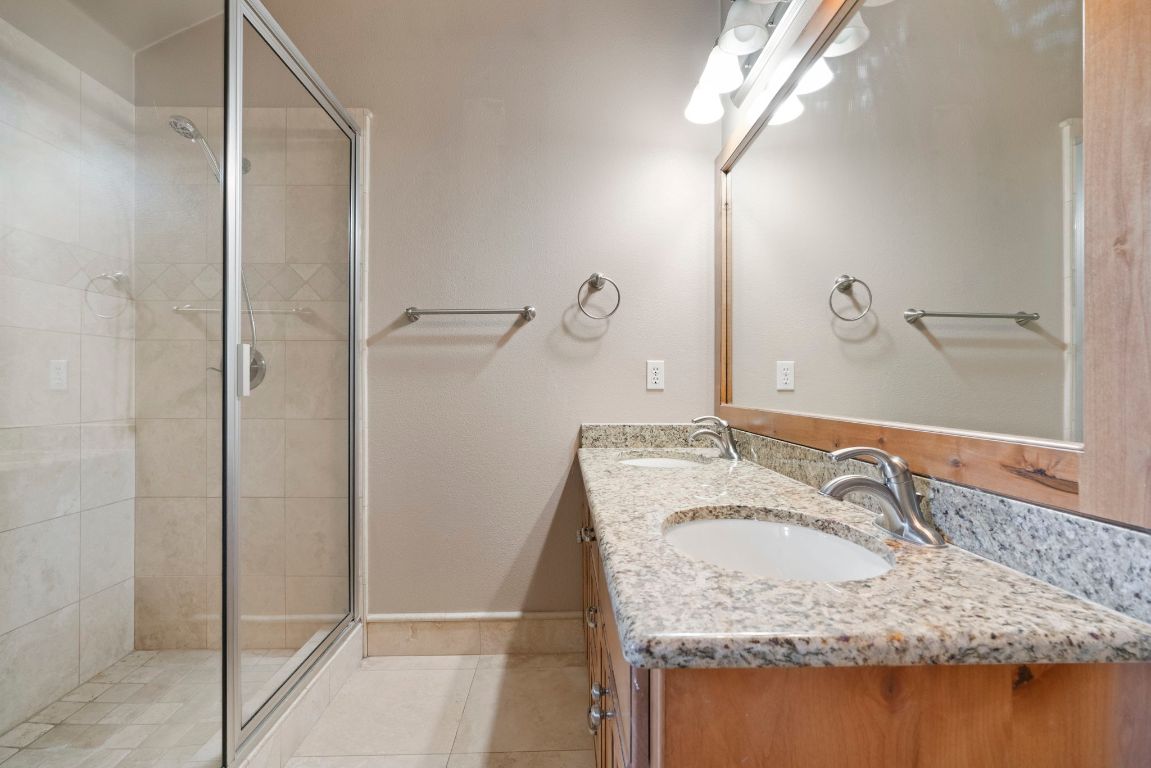 1237 Ridge Harbor Drive Spicewood, TX 78669 - Photo 23 of 40 a bathroom with a granite countertop sink and a mirror