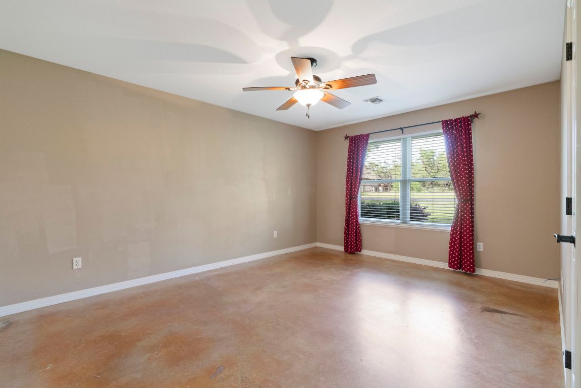 1237 Ridge Harbor Drive Spicewood, TX 78669 - Photo 26 of 40 an empty room with windows and fan