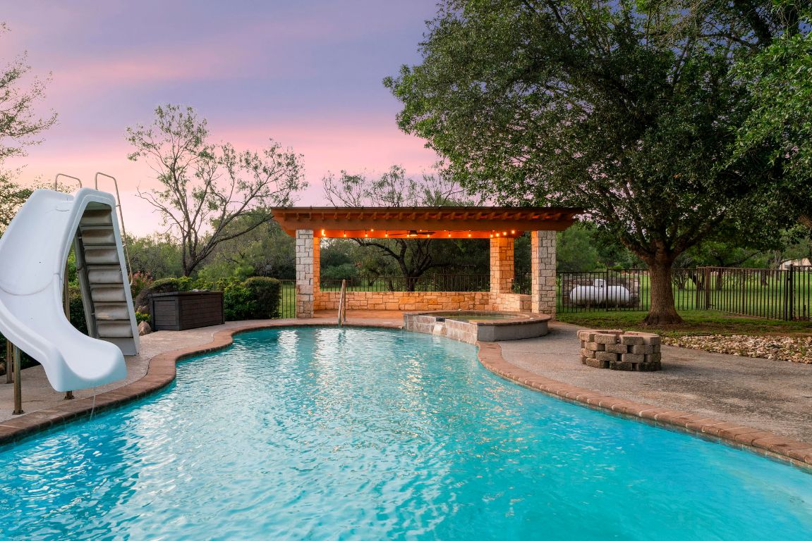 1237 Ridge Harbor Drive Spicewood, TX 78669 - Photo 32 of 40 a view of a house with backyard porch and sitting area