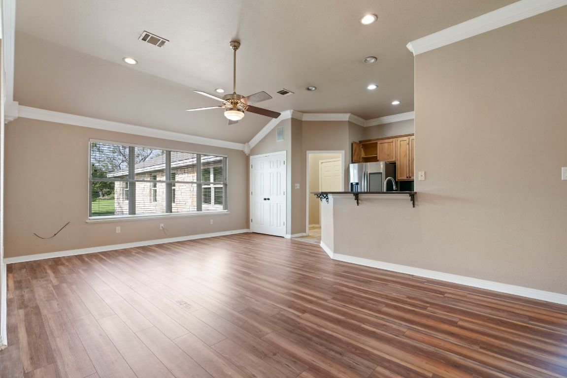 1237 Ridge Harbor Drive Spicewood, TX 78669 - Photo 5 of 40 a view of an empty room with window and wooden floor
