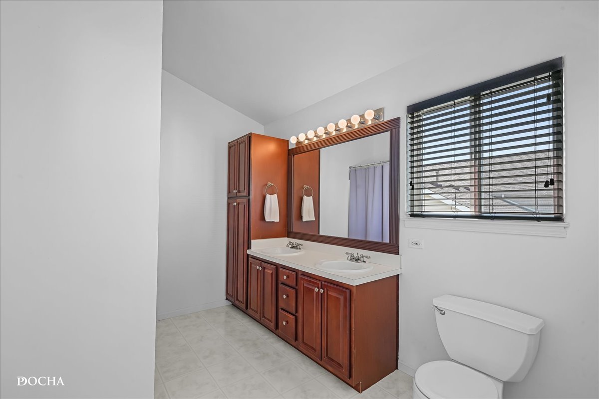 4301 Anthony Lane Plainfield, IL 60586 - Photo 19 of 31 a bathroom with a toilet a sink and a mirror