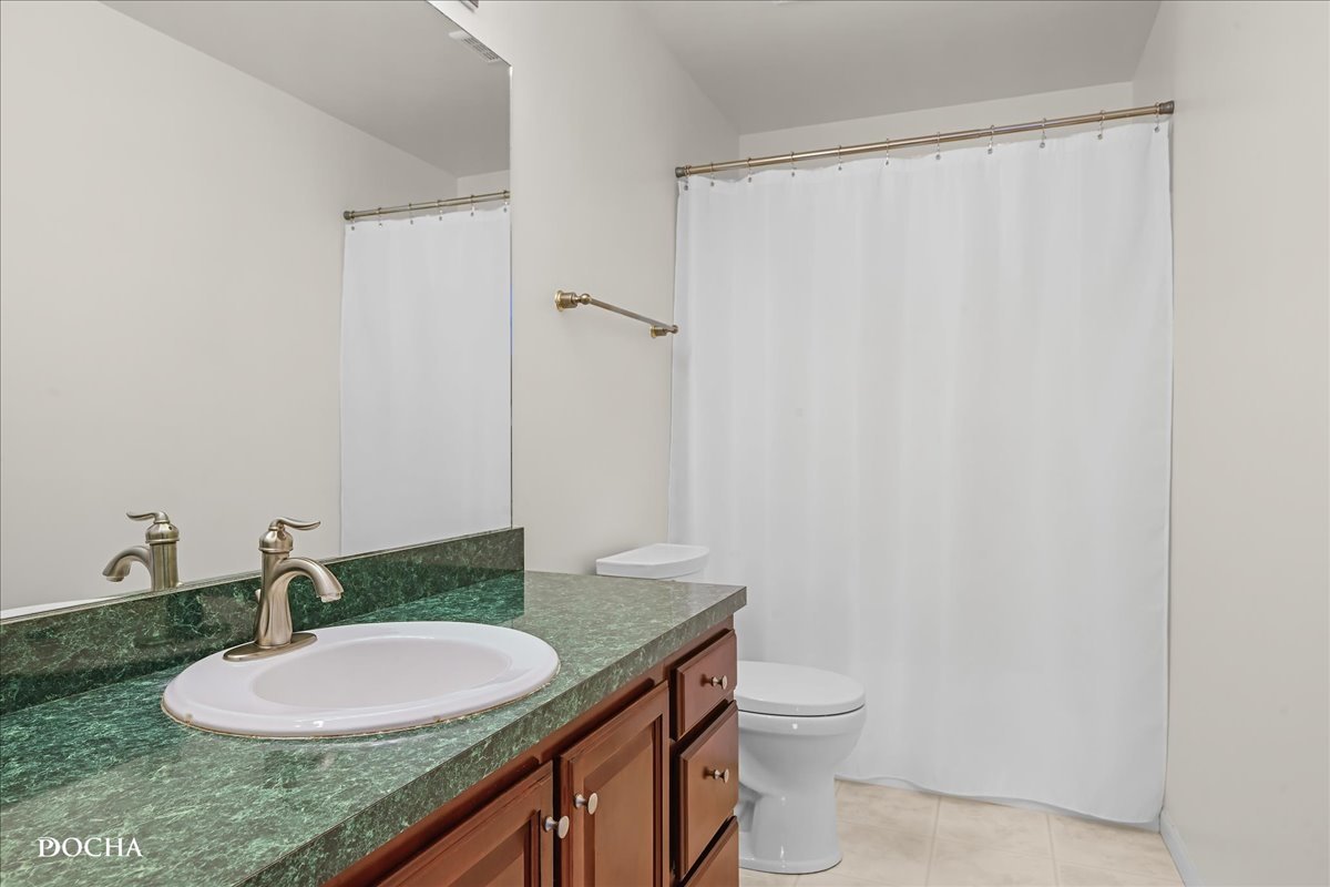 4301 Anthony Lane Plainfield, IL 60586 - Photo 23 of 31 a bathroom with a granite countertop sink a toilet and a mirror