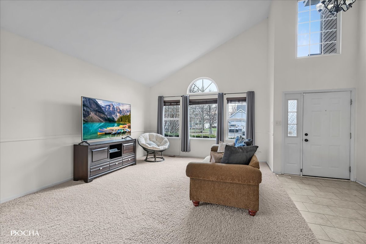 4301 Anthony Lane Plainfield, IL 60586 - Photo 3 of 31 a living room with furniture and a flat screen tv