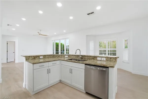 a kitchen that has a sink and a stove in it