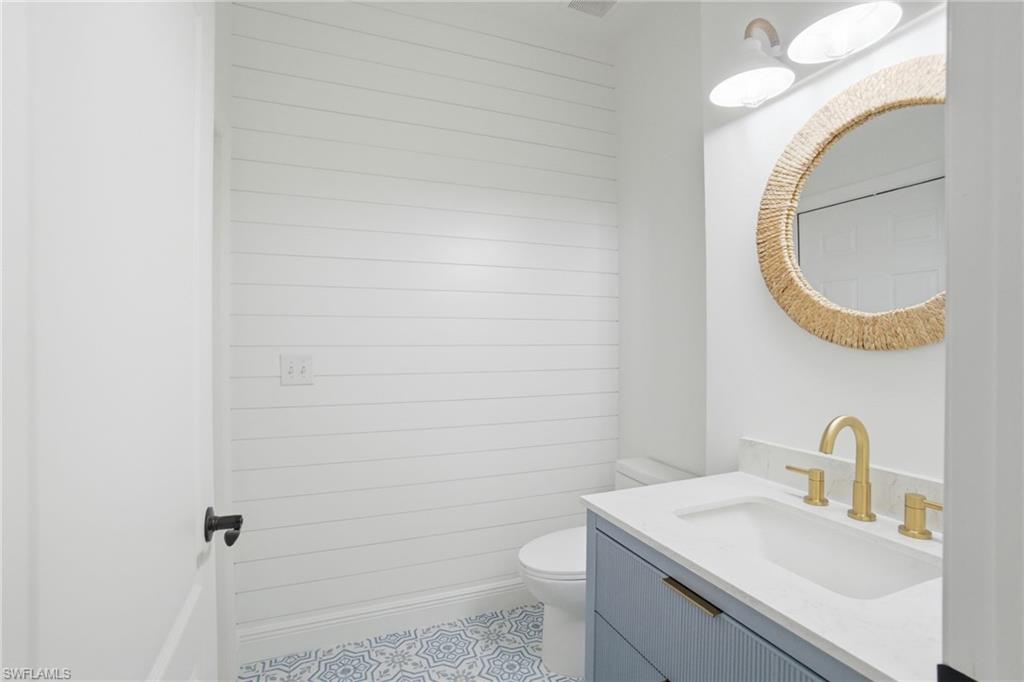 21314 Braxfield Loop Estero, FL 33928 - Photo 14 of 44 a bathroom with a sink a toilet and mirror