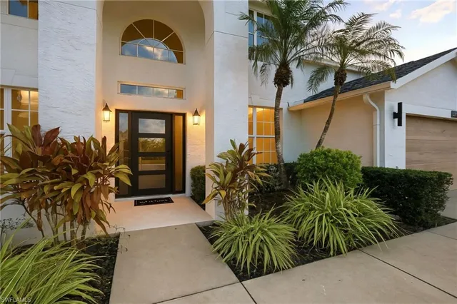a potted plant sitting in front of a house