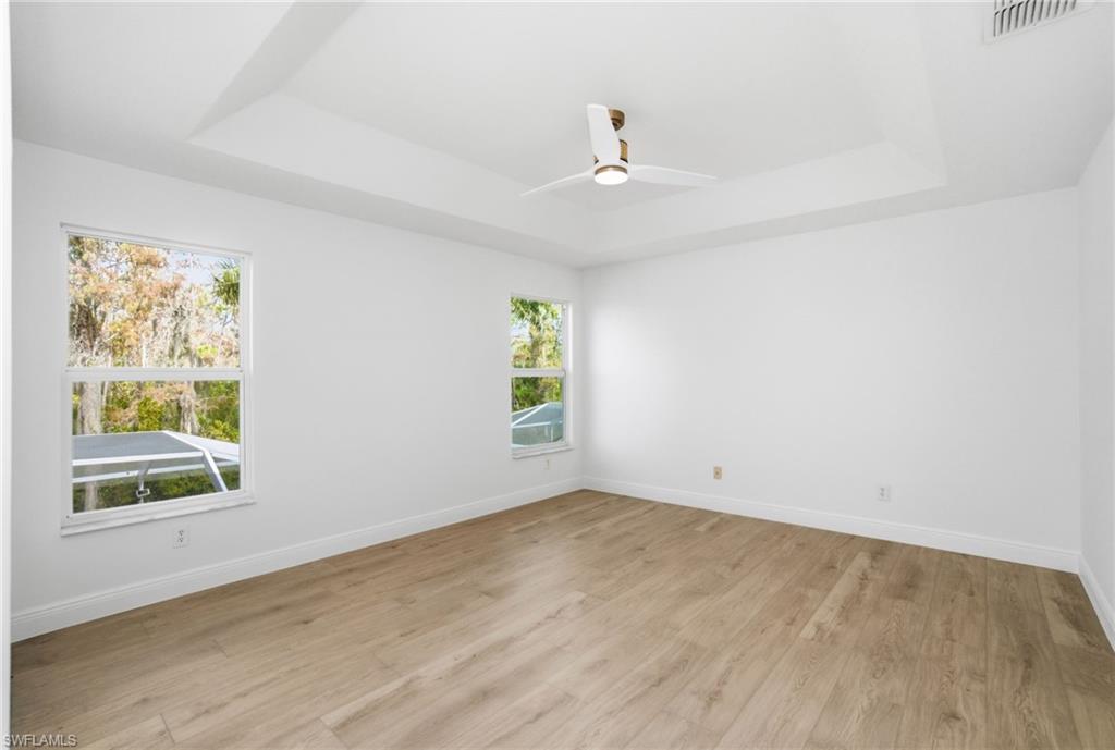 21314 Braxfield Loop Estero, FL 33928 - Photo 23 of 44 wooden floor in an empty room with a window