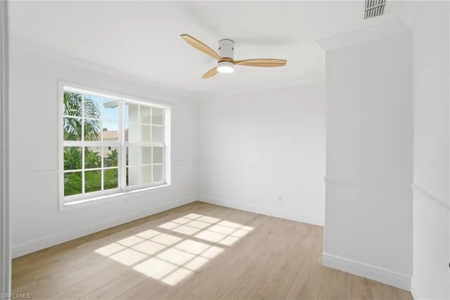 a view of a room with wooden floor and white walls