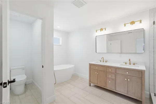 a spacious bedroom with a bed and a couch