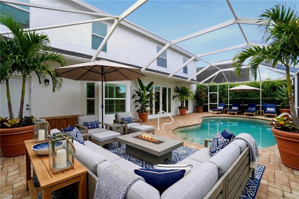 21314 Braxfield Loop Estero, FL 33928 - Photo 3 of 44 a view of a patio with couches and chairs under an umbrella