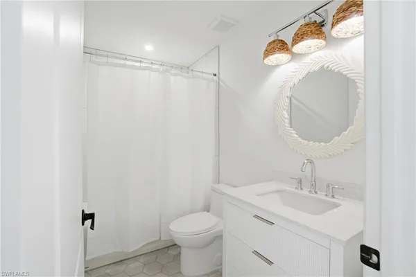 a bedroom with a large bed and a potted plant