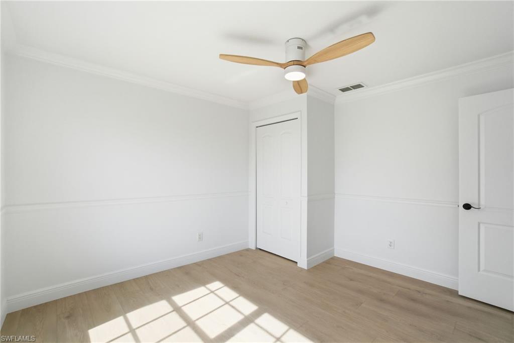 21314 Braxfield Loop Estero, FL 33928 - Photo 34 of 44 a view of a room with wooden floor and white walls