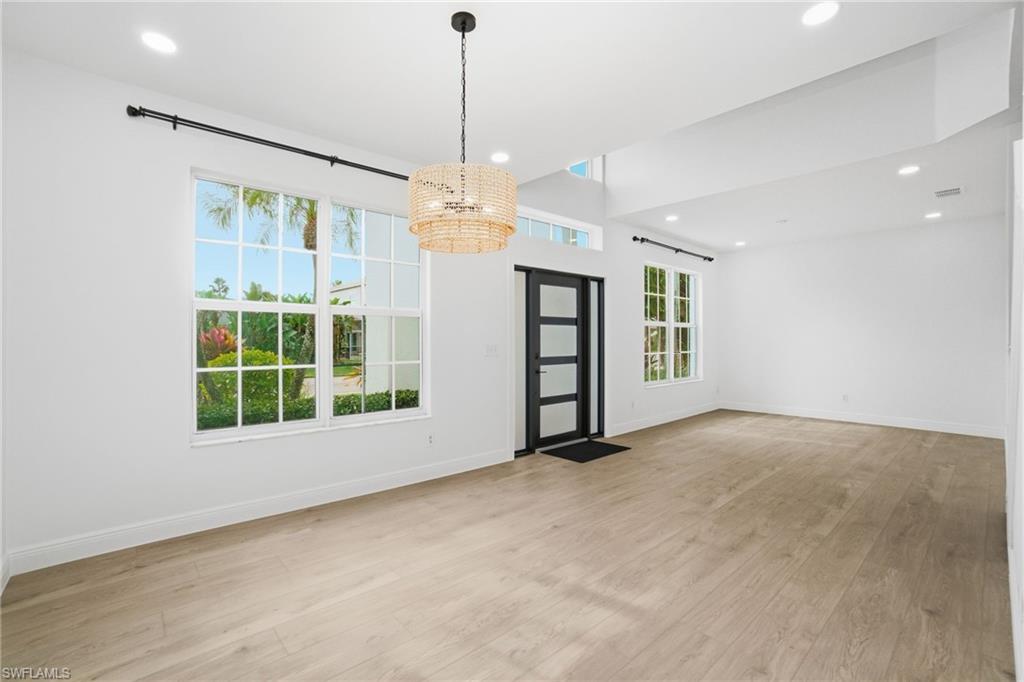 21314 Braxfield Loop Estero, FL 33928 - Photo 6 of 44 a view of an empty room with a window and chandelier