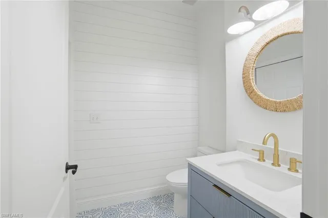 a bathroom with a sink a toilet and mirror