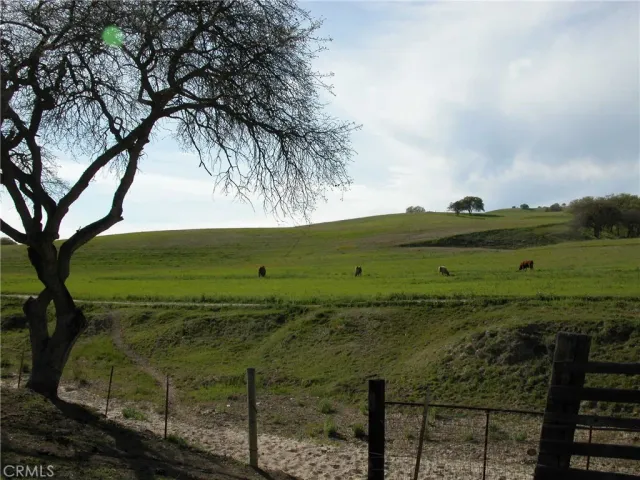 a view of wooden house with a yard