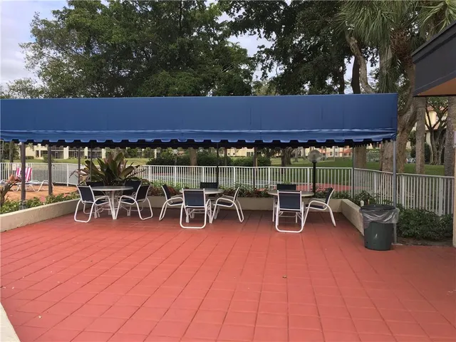 a view of a patio with a table and chairs