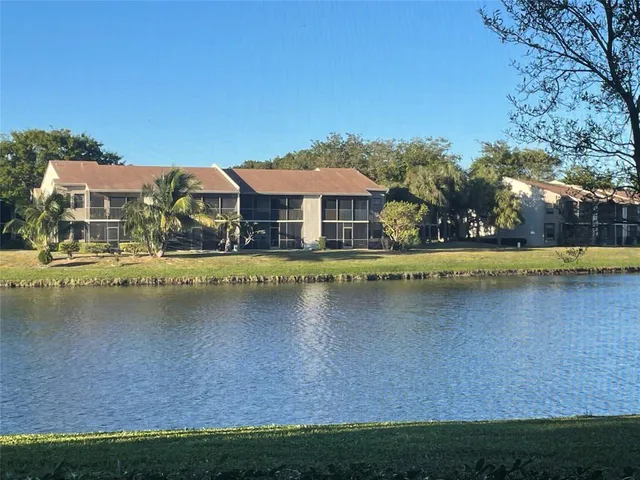 a view of a house with a small yard and potted plants