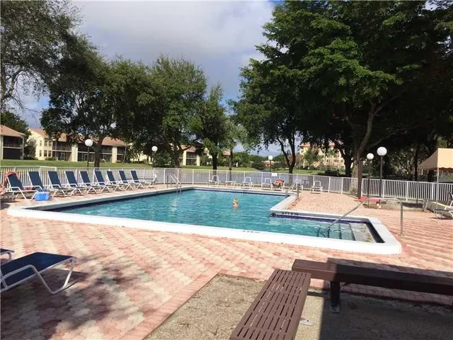 a view of a swimming pool with a patio