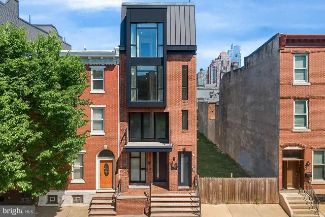 a front view of a residential apartment building with a yard