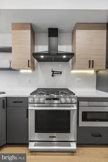 a stove top oven sitting inside of a kitchen